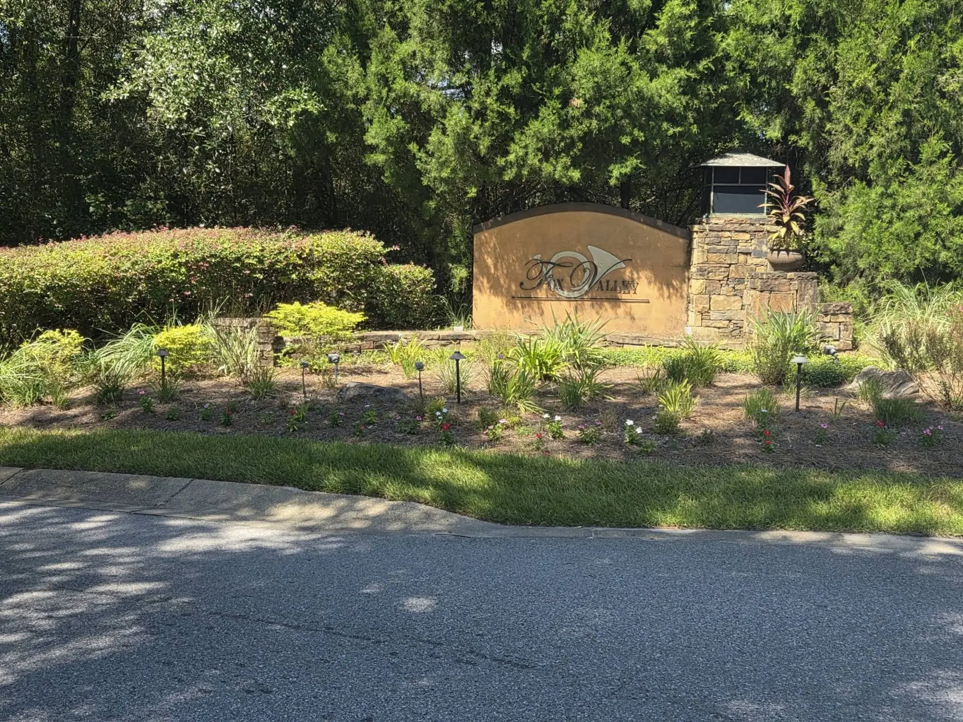The Fox Valley entrance sign surrounded by landscaped flower beds