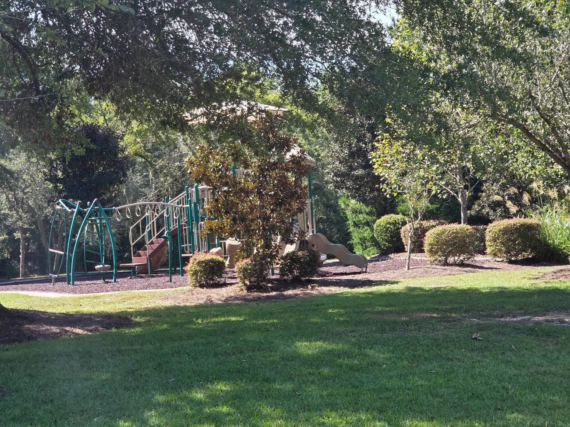 The Fox Valley park playground framed by shade trees